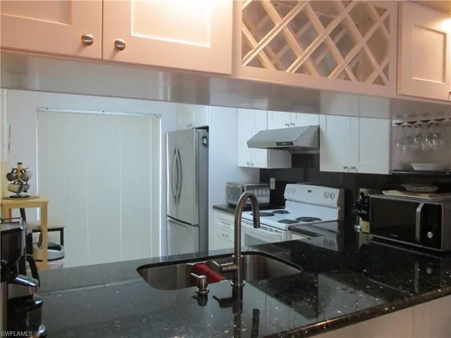 a kitchen with a sink cabinets and appliances