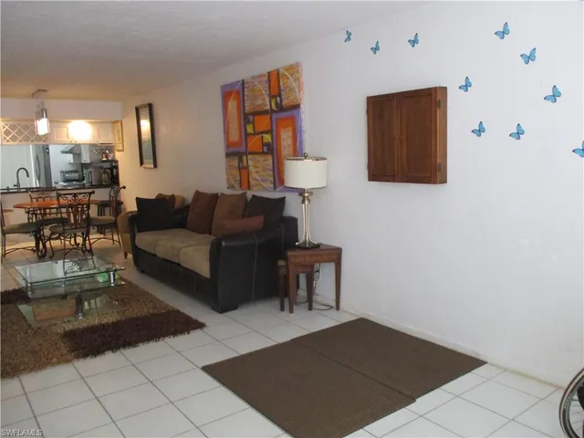 a living room with furniture and a painting on the wall