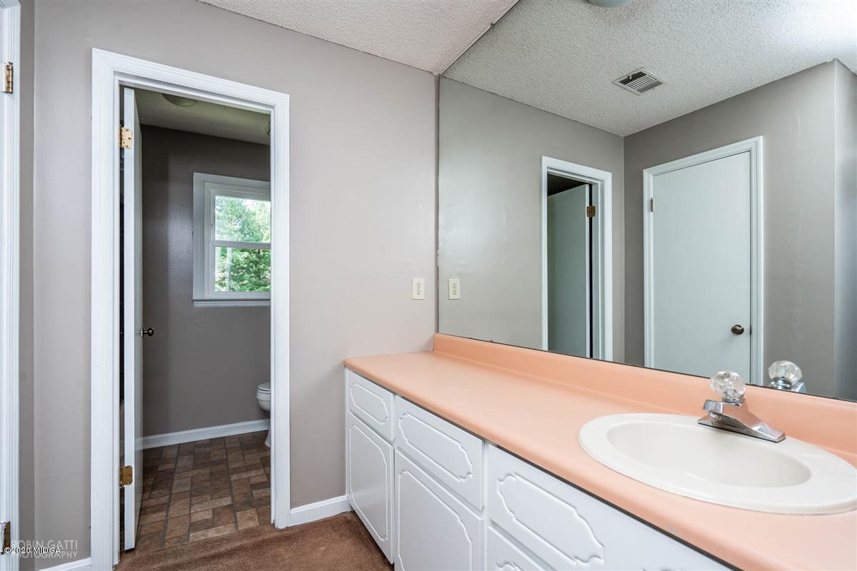 243 Lake Joy Road Perry, GA 31069 - Photo 14 of 29 a bathroom with a sink and a mirror