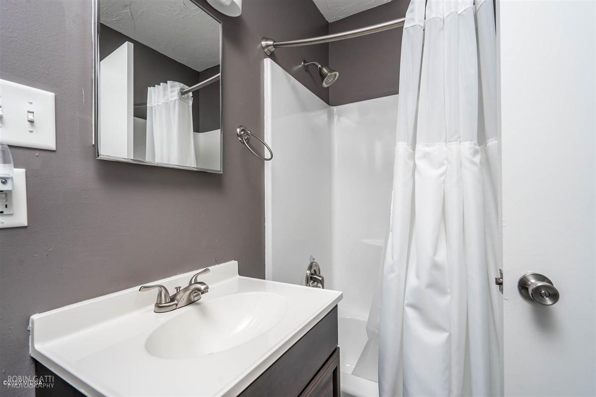 243 Lake Joy Road Perry, GA 31069 - Photo 17 of 29 a bathroom with a sink and mirror