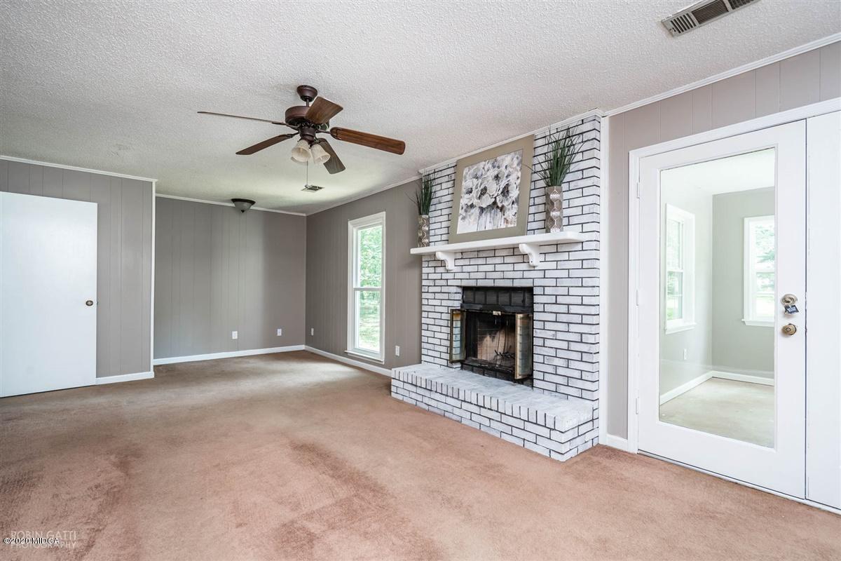 243 Lake Joy Road Perry, GA 31069 - Photo 3 of 29 a view of an empty room with fireplace and a window
