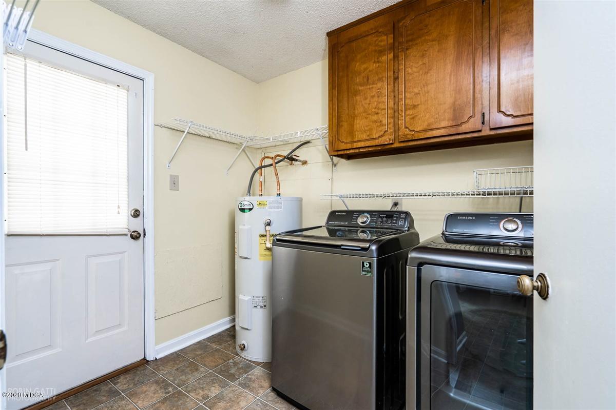 243 Lake Joy Road Perry, GA 31069 - Photo 22 of 29 a view of a kitchen with stainless steel appliances granite countertop cabinets and a stove top oven