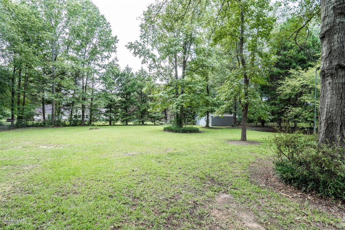 243 Lake Joy Road Perry, GA 31069 - Photo 27 of 29 a view of a field with trees in the background