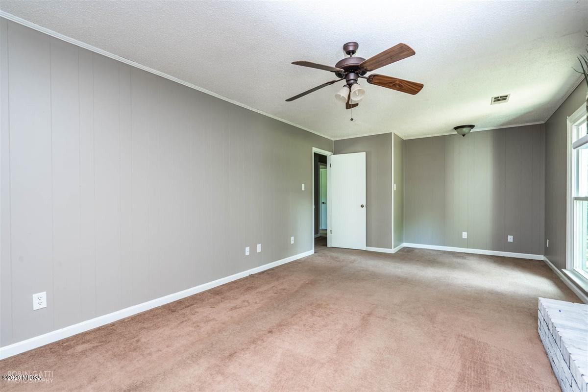 243 Lake Joy Road Perry, GA 31069 - Photo 4 of 29 a view of an empty room with a ceiling fan