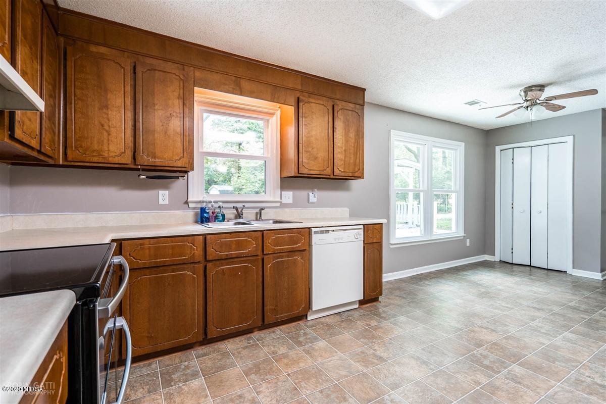 243 Lake Joy Road Perry, GA 31069 - Photo 7 of 29 a kitchen with a sink cabinets appliances and a window