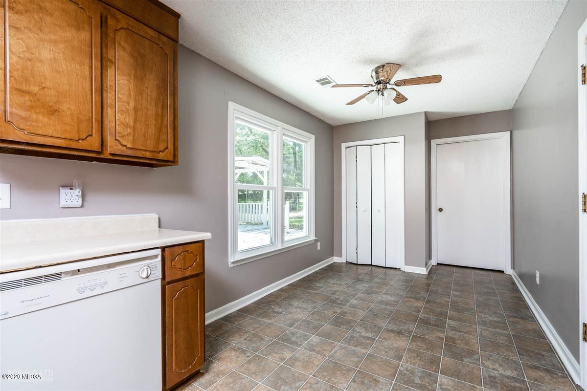 243 Lake Joy Road Perry, GA 31069 - Photo 8 of 29 a view of an empty room with window and chandelier fan