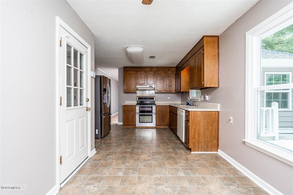 243 Lake Joy Road Perry, GA 31069 - Photo 9 of 29 a kitchen with stainless steel appliances granite countertop a refrigerator and a sink