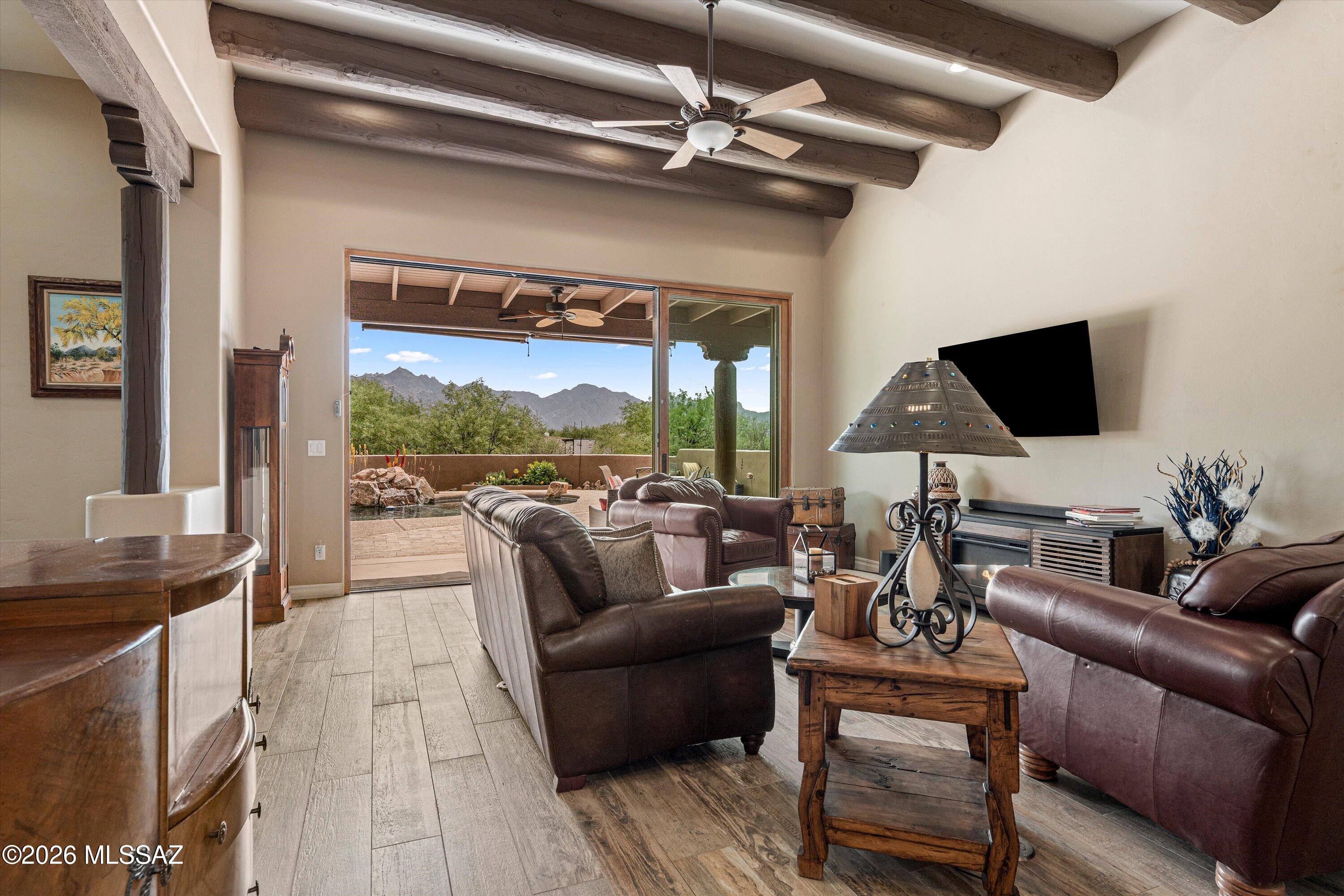 4760 East Wagon Train Road Tucson, AZ 85739 - Photo 23 of 38 a living room with furniture and a flat screen tv
