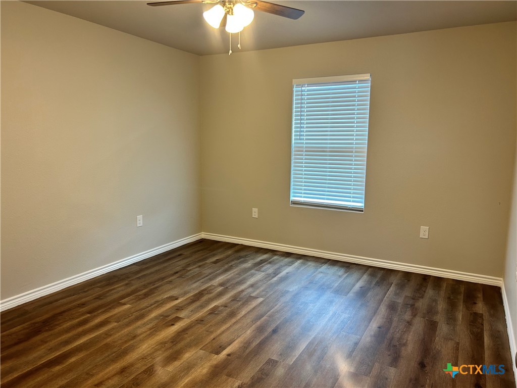 2618 Leroy Lane, Unit B Belton, TX 76513 - Photo 11 of 12 a view of an empty room with wooden floor and a window