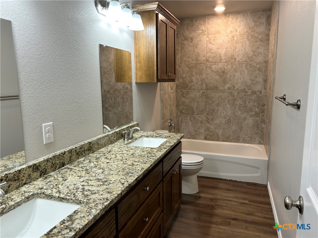 2618 Leroy Lane, Unit B Belton, TX 76513 - Photo 12 of 12 a bathroom with a granite countertop sink toilet and shower