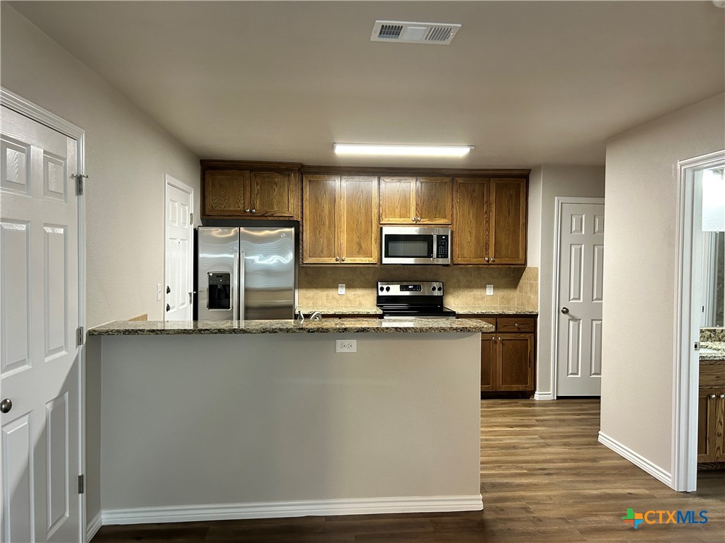 2618 Leroy Lane, Unit B Belton, TX 76513 - Photo 5 of 12 a kitchen with stainless steel appliances a microwave a sink and cabinets