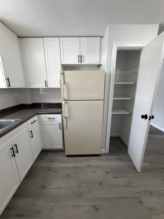 85 Trapelo Road, Unit 40 Waltham, MA 02452 - Photo 2 of 15 a utility room with cabinets washer and dryer