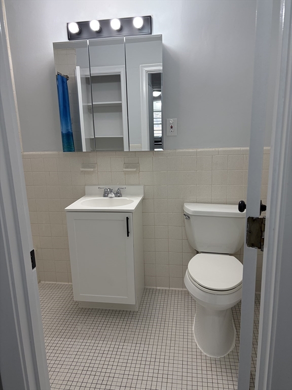 85 Trapelo Road, Unit 40 Waltham, MA 02452 - Photo 9 of 15 a white toilet sitting next to a bathroom sink