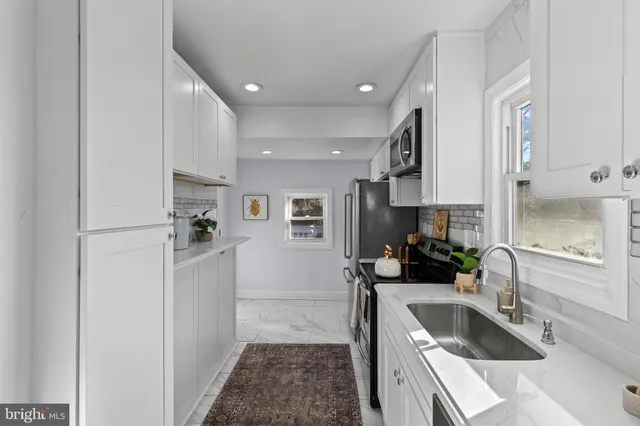 a kitchen with refrigerator cabinets and a sink