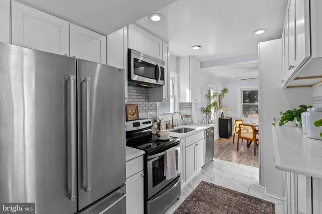 a kitchen with stainless steel appliances a refrigerator stove and microwave