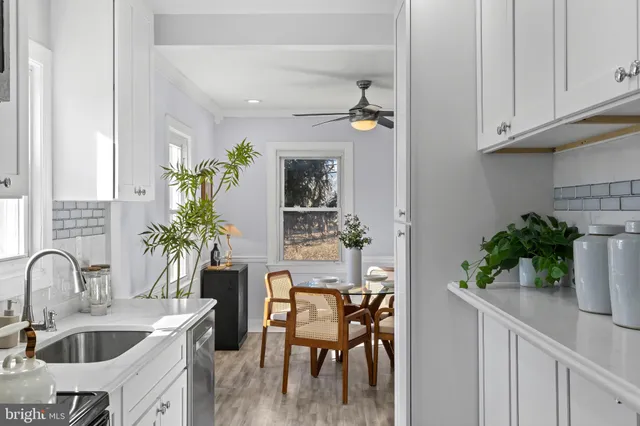 a kitchen with sink and white cabinets