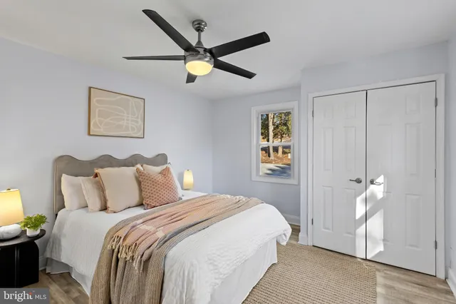 a bedroom with a bed and a painting on the wall