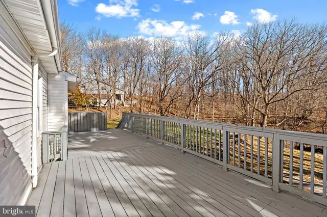 a view of balcony with wooden floor and fence