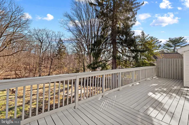 a view of a house with a large tree and a yard