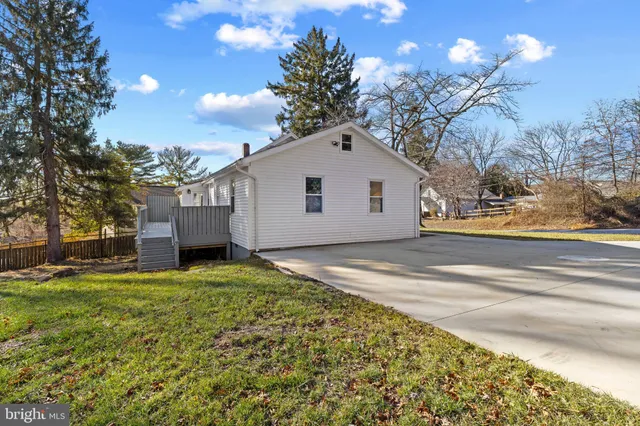 a yard with trees in the background