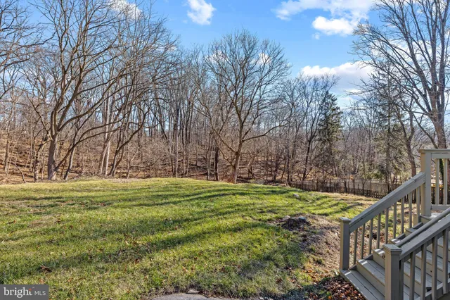 a view of a yard with snow on the road