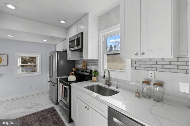 a kitchen with a sink stove and refrigerator