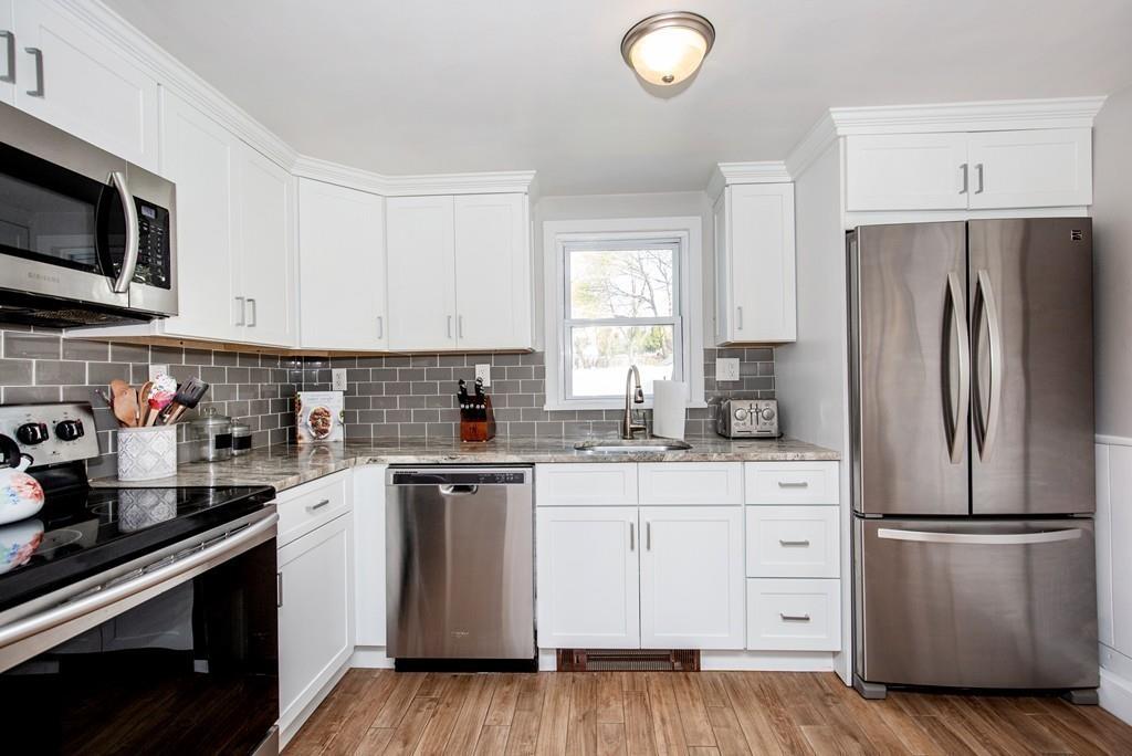 21 Forest Street Peabody, MA 01960 - Photo 11 of 29 a kitchen with white cabinets stainless steel appliances and sink