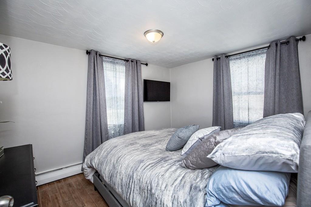 21 Forest Street Peabody, MA 01960 - Photo 12 of 29 a bedroom with a bed and a flat screen tv