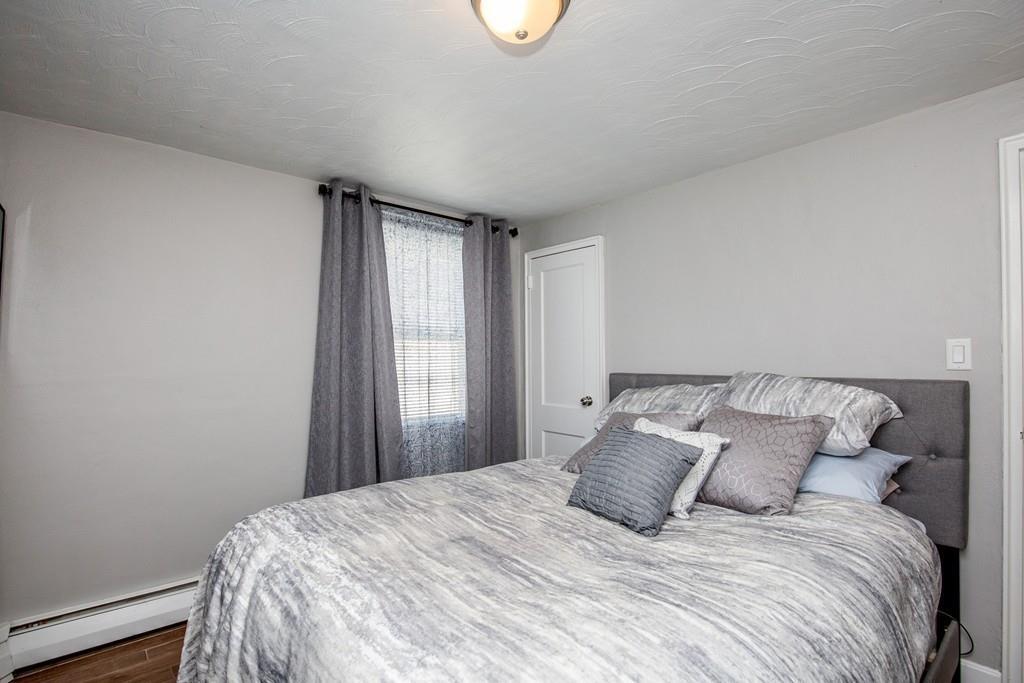 21 Forest Street Peabody, MA 01960 - Photo 13 of 29 a bedroom with a bed and a window