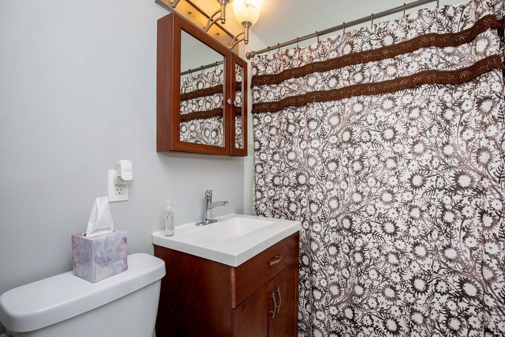 21 Forest Street Peabody, MA 01960 - Photo 15 of 29 a bathroom with a sink and a mirror