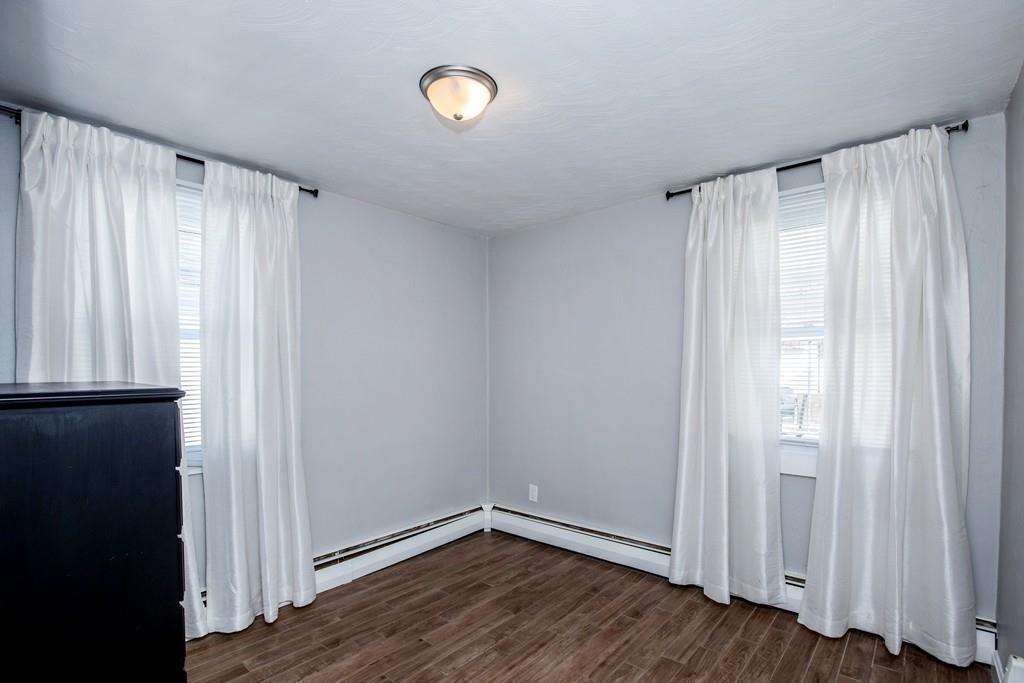 21 Forest Street Peabody, MA 01960 - Photo 16 of 29 a view of an empty room with wooden floor and a window