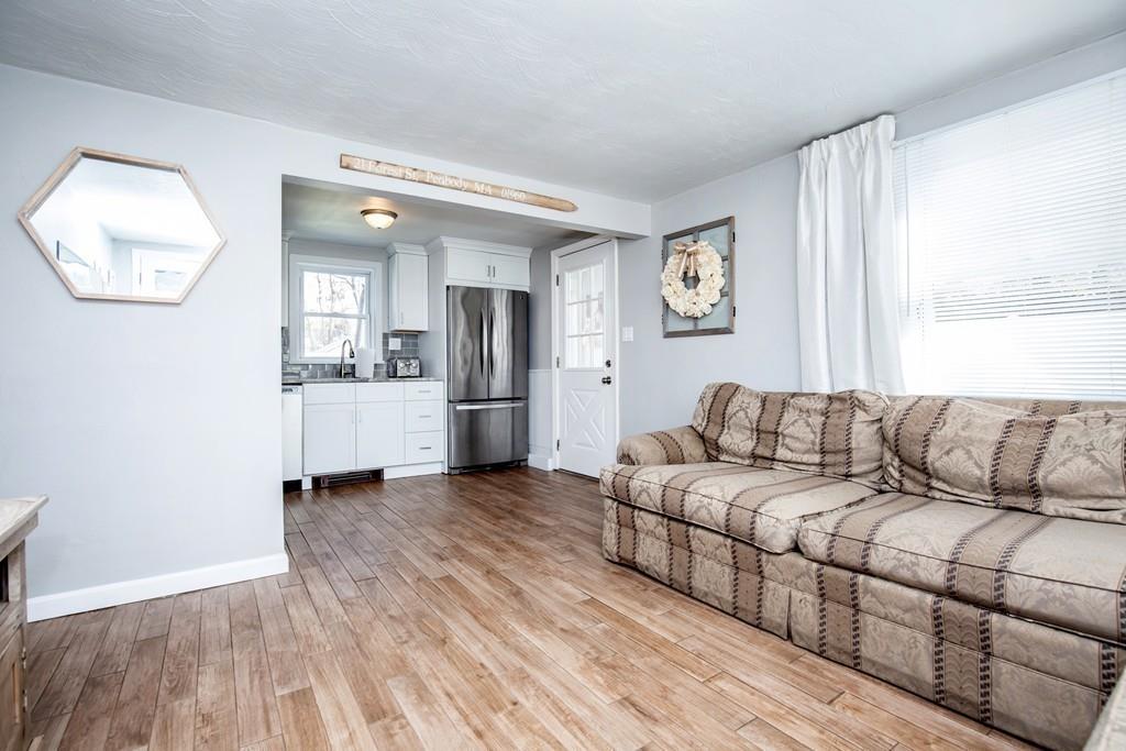 21 Forest Street Peabody, MA 01960 - Photo 6 of 29 a living room with a couch and a window