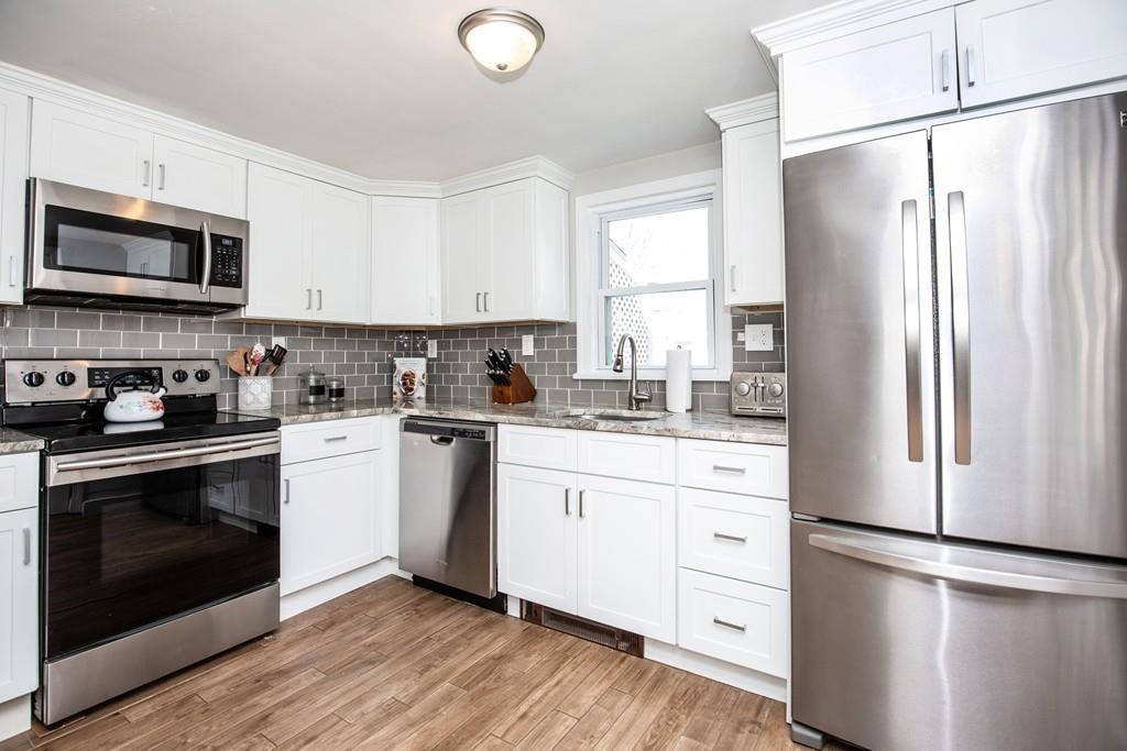 21 Forest Street Peabody, MA 01960 - Photo 8 of 29 a kitchen with stainless steel appliances a refrigerator sink and microwave