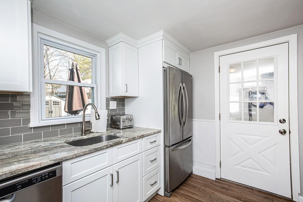 21 Forest Street Peabody, MA 01960 - Photo 10 of 29 a kitchen with stainless steel appliances granite countertop a refrigerator and a sink