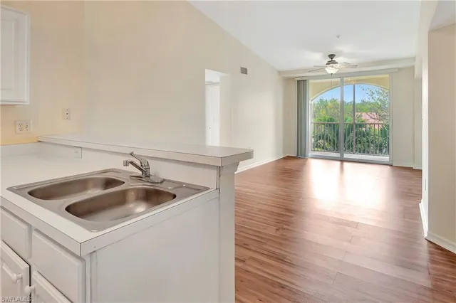 a bedroom with furniture and a large window