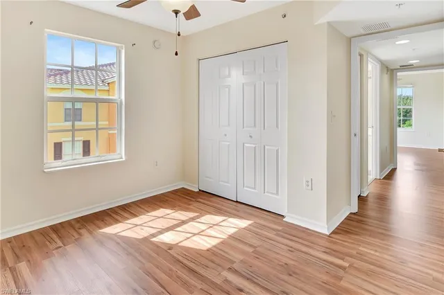 a view of walk in closet with empty racks