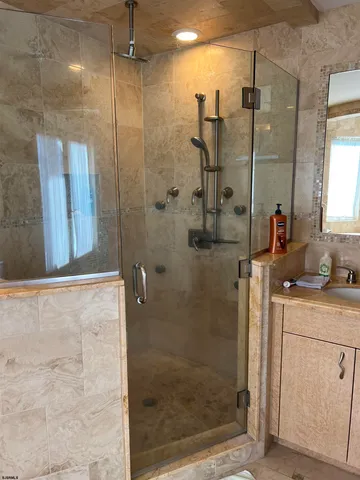 a bathroom with a shower and a sink