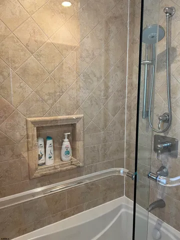 a bathroom with a bathtub and a shower