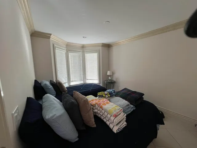 a bedroom with bed and a window