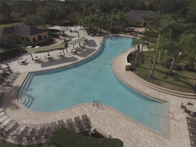 a view of a tennis ground with large trees