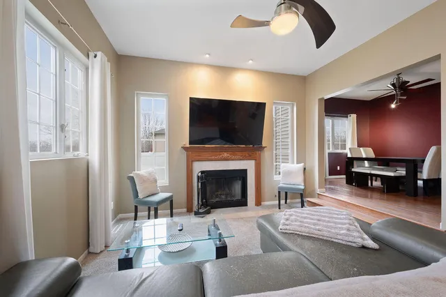 a living room with fireplace furniture and a flat screen tv