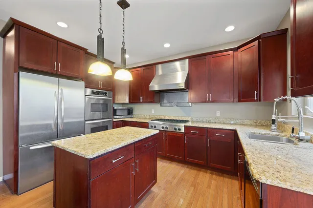 a dining room with furniture a chandelier and wooden floor