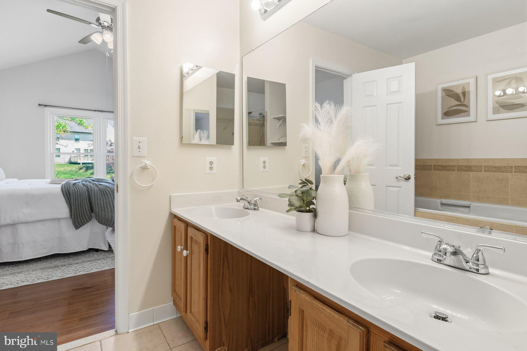 14215 Greenview Drive Laurel, MD 20708 - Photo 22 of 35 a en suite bathroom with a double vanity sink and a mirror