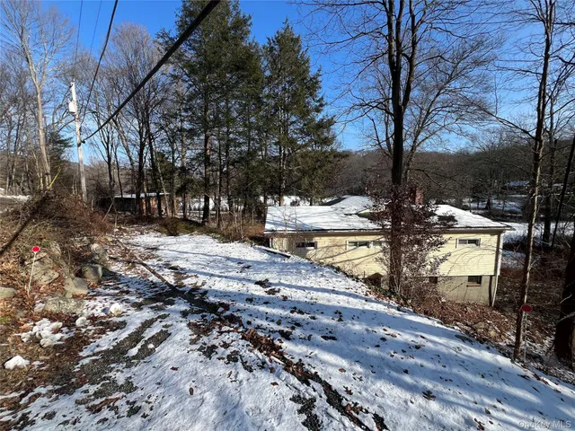 a view of a yard with wooden fence