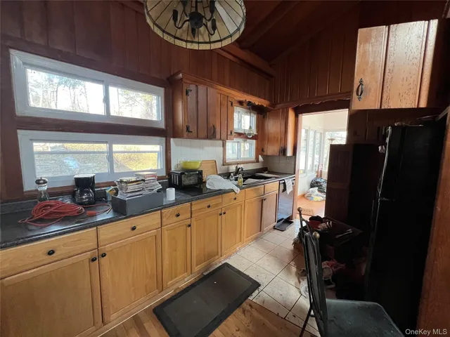 a kitchen with refrigerator and window