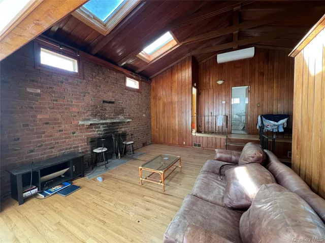 a living room with furniture a dining table and chairs with kitchen view