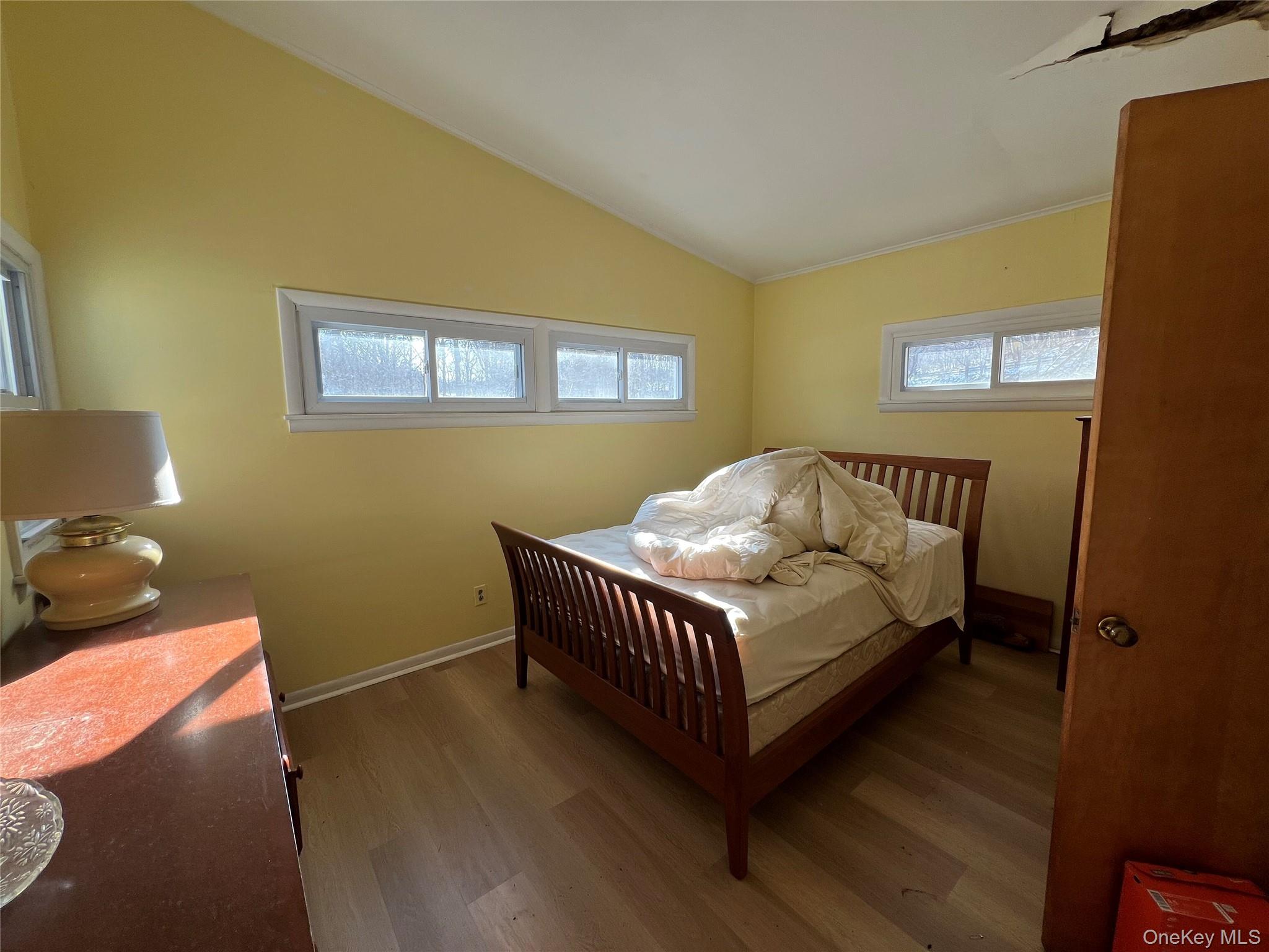 298 Old Albany Post Road Garrison, NY 10524 - Photo 10 of 18 a bedroom with a bed and wooden floor