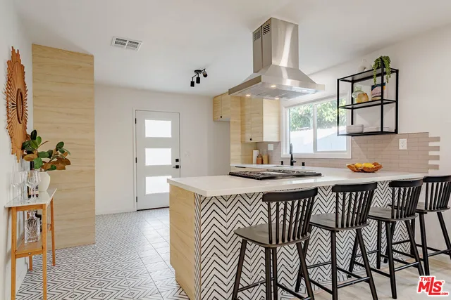 a kitchen with stainless steel appliances a sink stove and cabinets