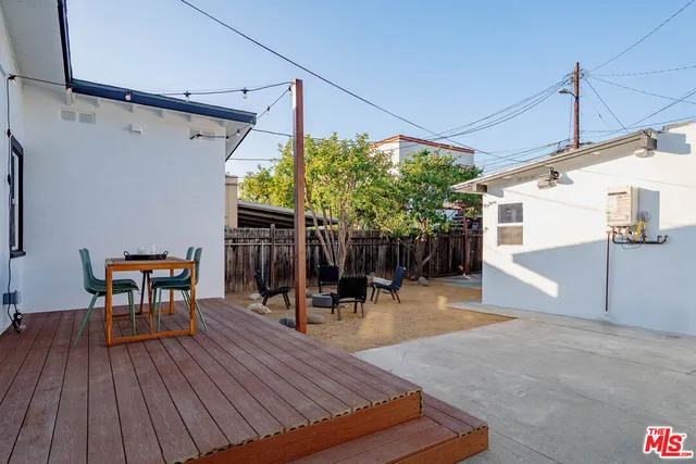 a backyard of a house with table and chairs