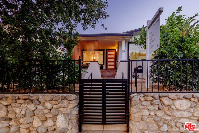a view of a patio with table and chairs and potted plants